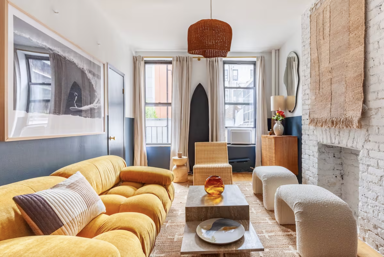 a living room with furniture a fireplace and a window