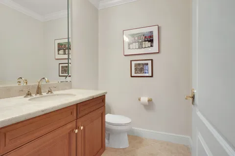 a bathroom with a toilet a sink and mirror