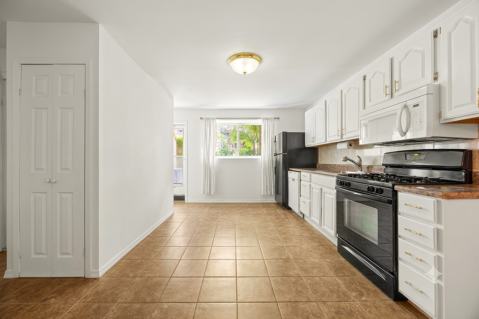 726A Union Street, Unit 1 Brooklyn, NY 11215 - Photo 6 of 13 a kitchen with stainless steel appliances granite countertop a stove a sink and a refrigerator