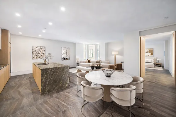 a living room with dining table and wooden floor