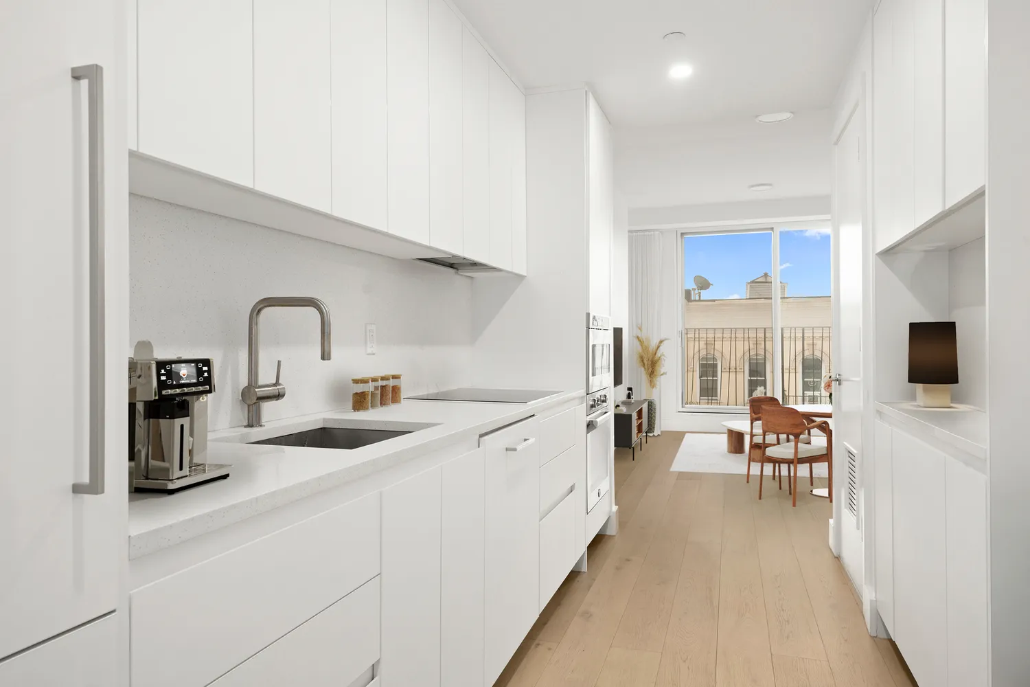 a kitchen with sink and view of living room