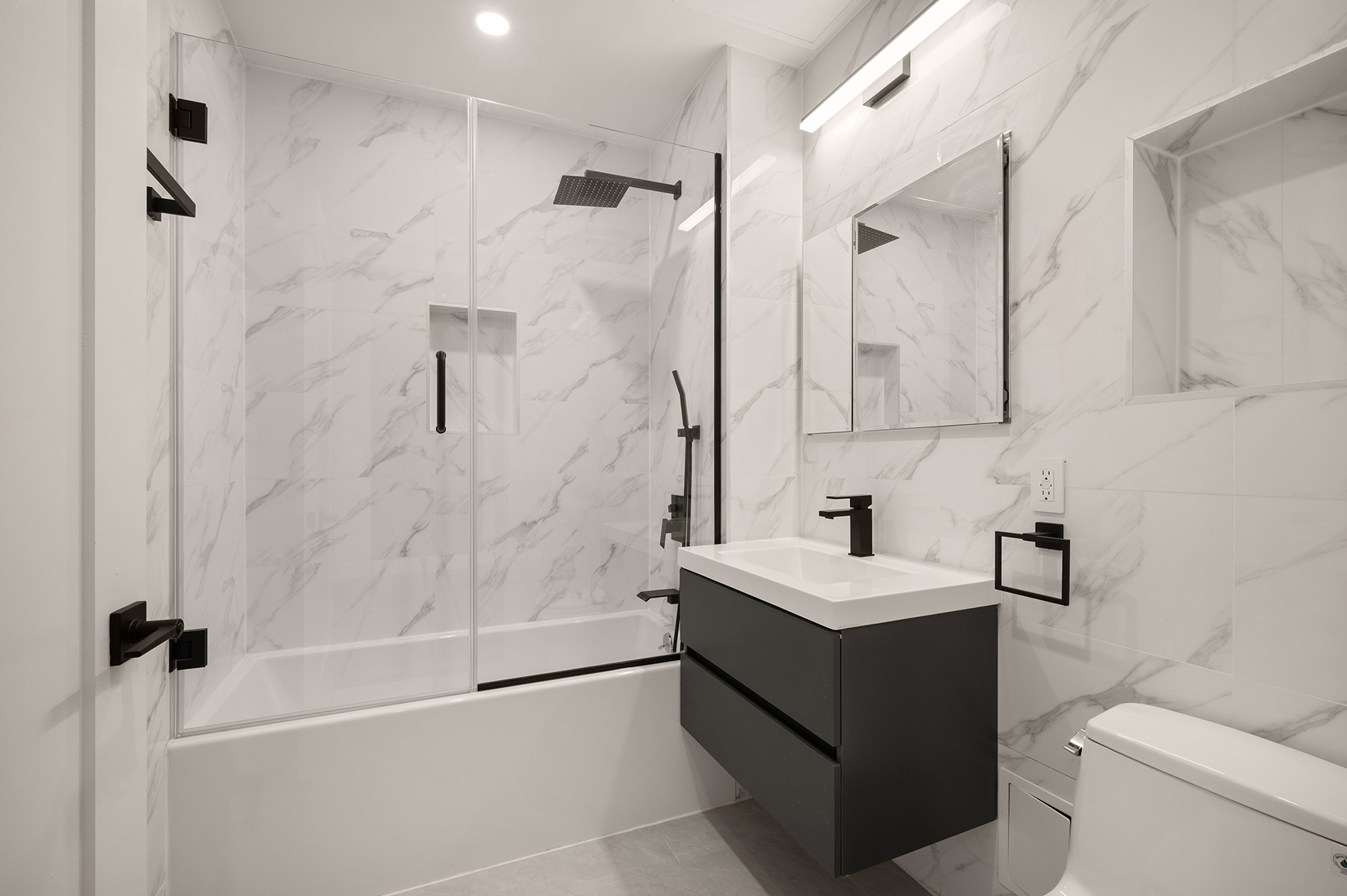 59 West 70th Street, Unit 4 Manhattan, NY 10023 - Photo 12 of 15 a bathroom with a sink vanity toilet and shower