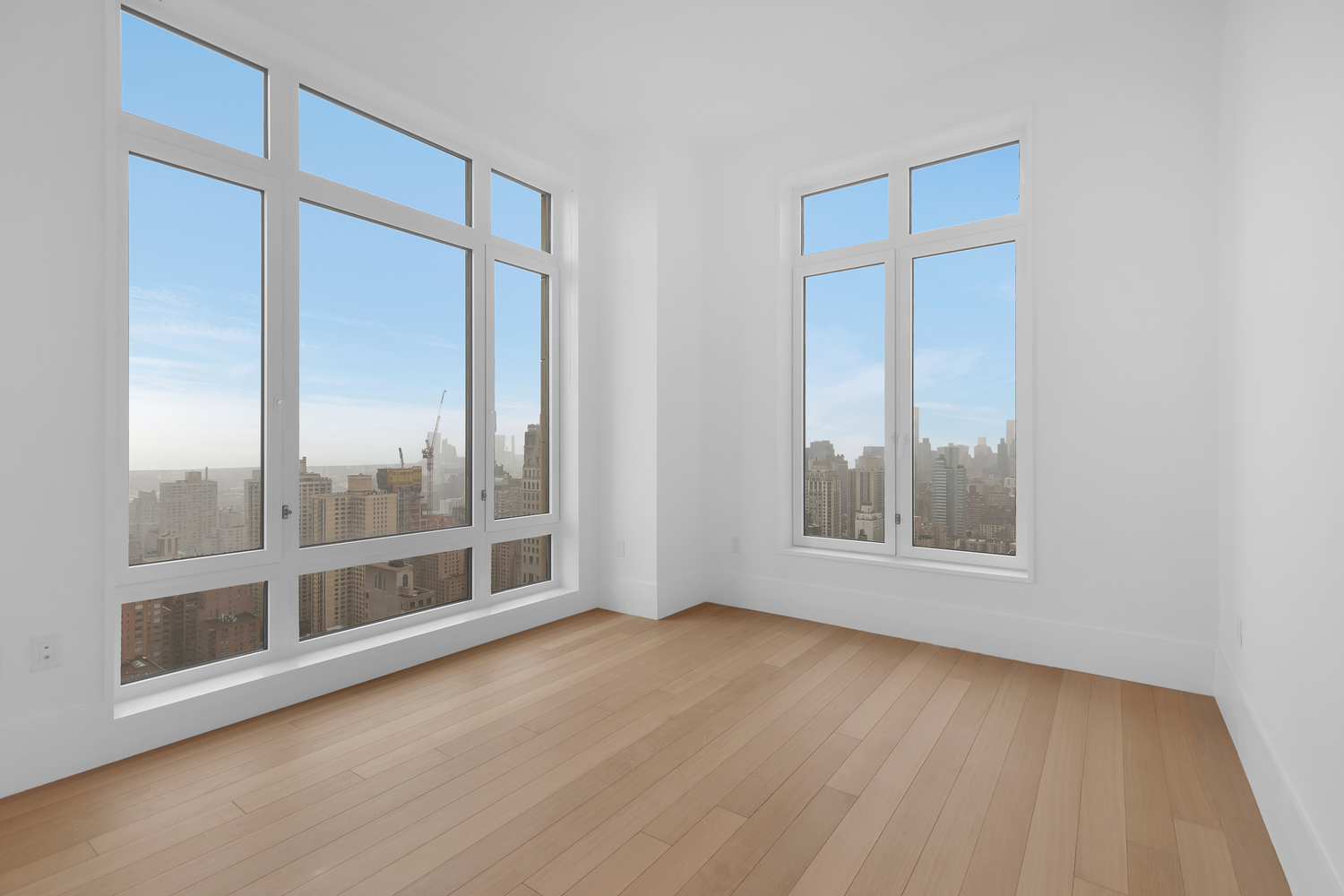 200 East 83rd Street, Unit 34A Manhattan, NY 10028 - Photo 16 of 34 an empty room with wooden floor and windows