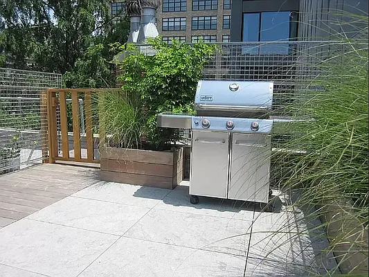 20 Renwick Street, Unit AB Manhattan, NY 10013 - Photo 6 of 9 a view of a patio with table and chairs with barbeque grill and wooden fence