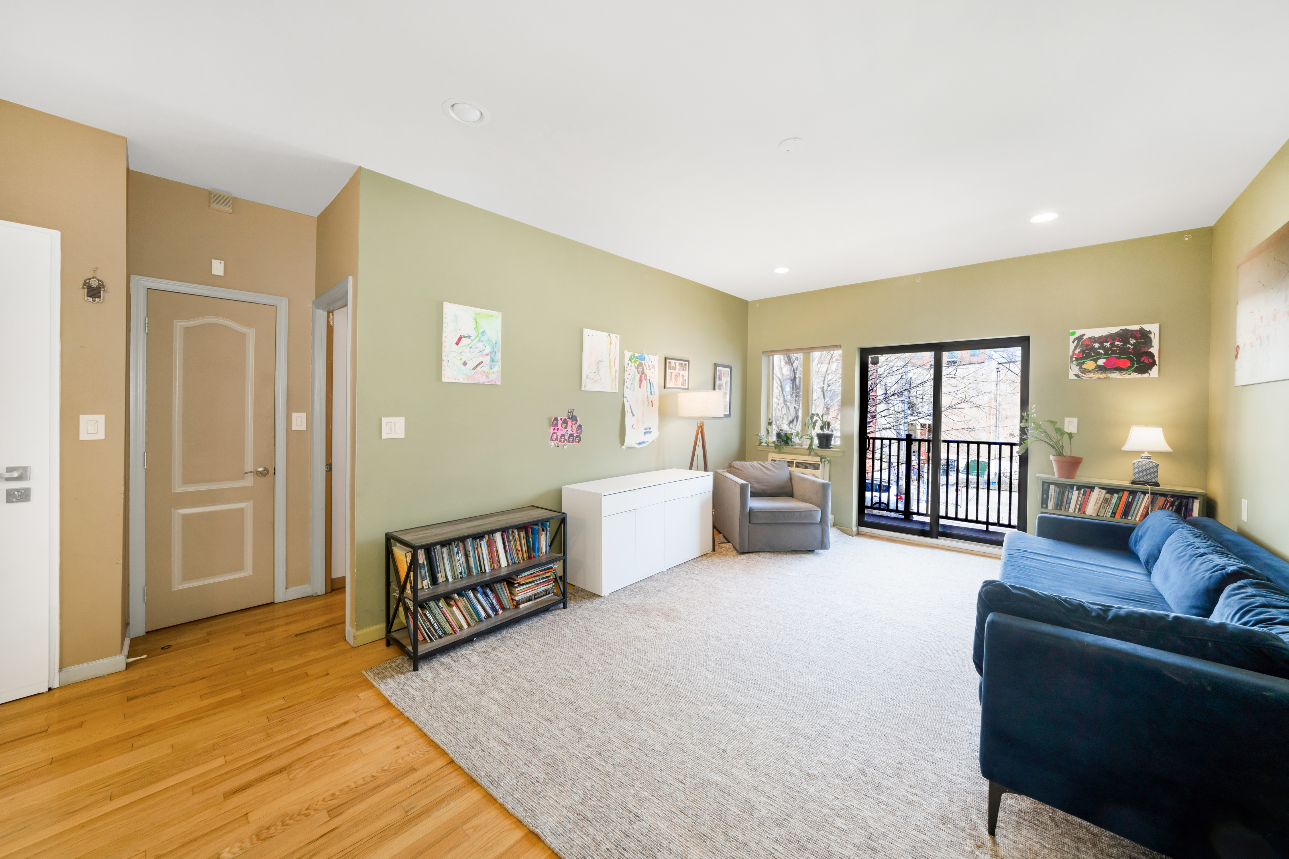 2356 61st Street, Unit 1B Brooklyn, NY 11204 - Photo 2 of 10 a spacious bedroom with a bed a couch and large window