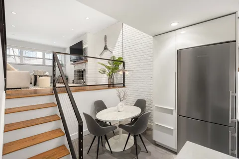 a dining room with furniture and window