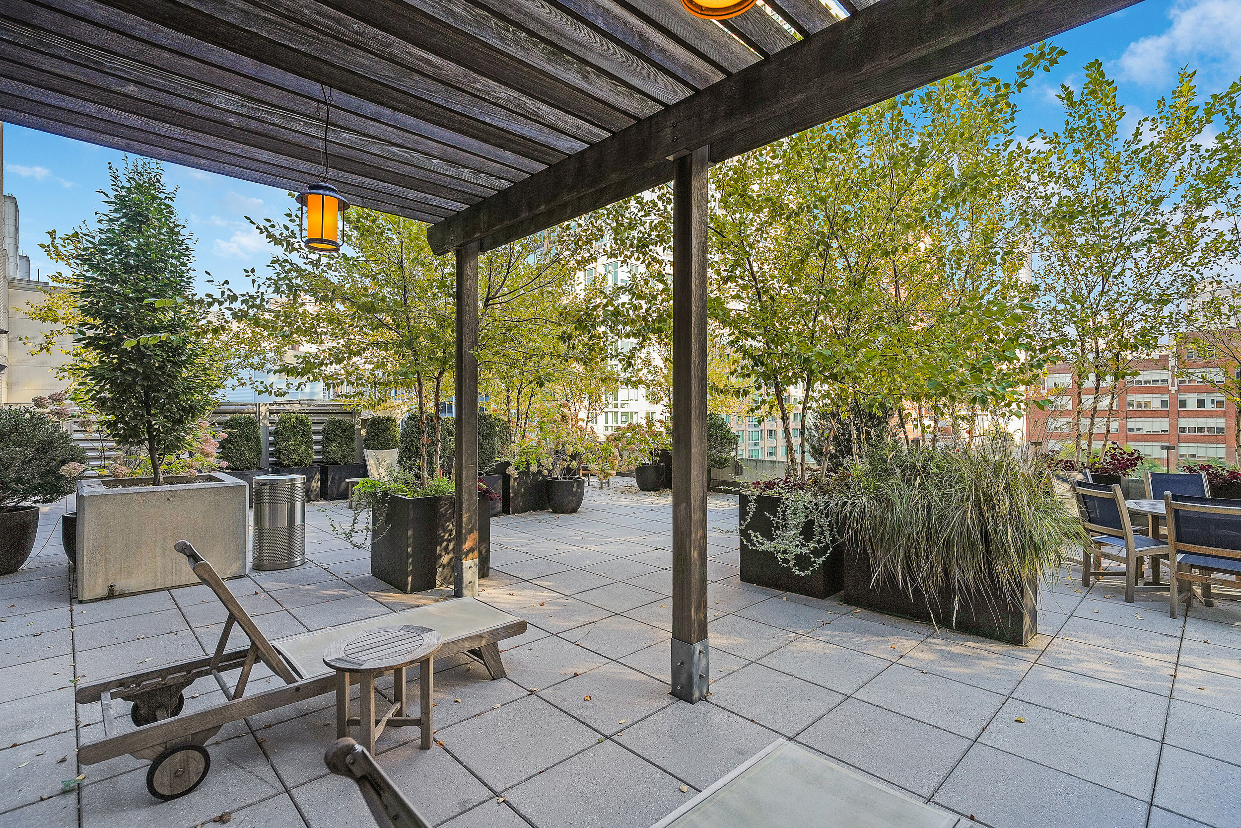 80 Riverside Boulevard, Unit 4H Manhattan, NY 10069 - Photo 9 of 17 a view of a patio with table and chairs and potted plants