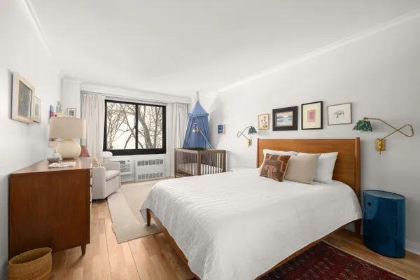 a bedroom with a bed and a large mirror