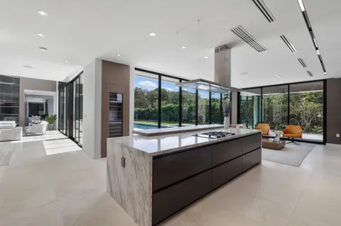a living room with furniture and large windows