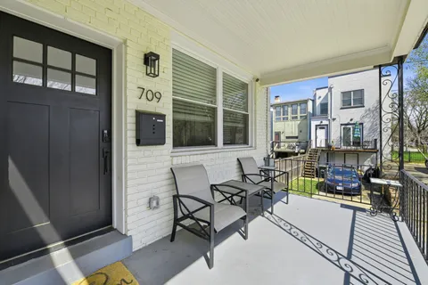a building outdoor space with patio furniture and potted plants