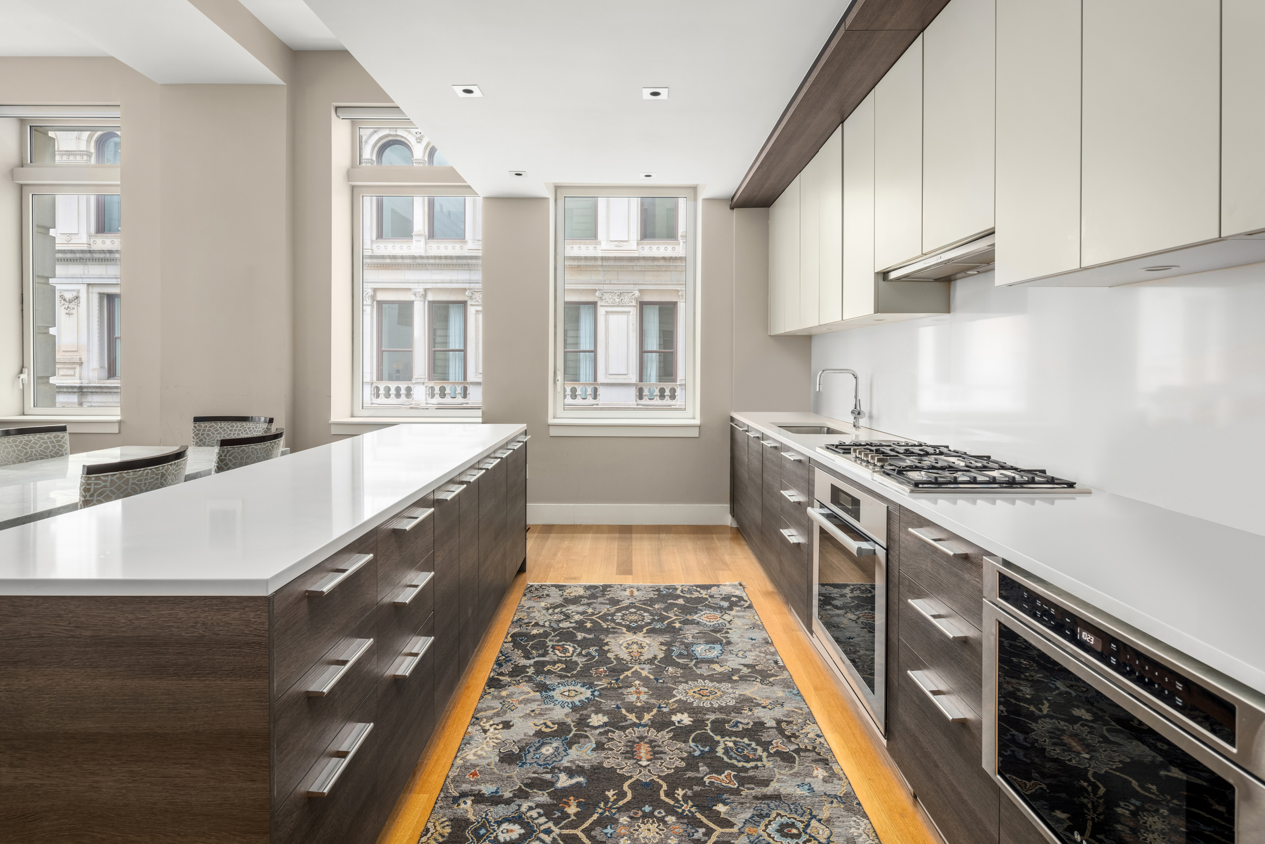 101 Leonard Street, Unit 2E Manhattan, NY 10013 - Photo 5 of 16 a kitchen with stainless steel appliances granite countertop a stove and a sink