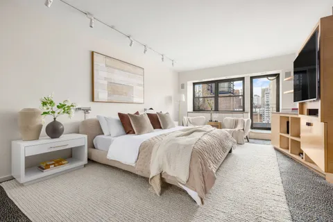 a bed room with bed and a large window