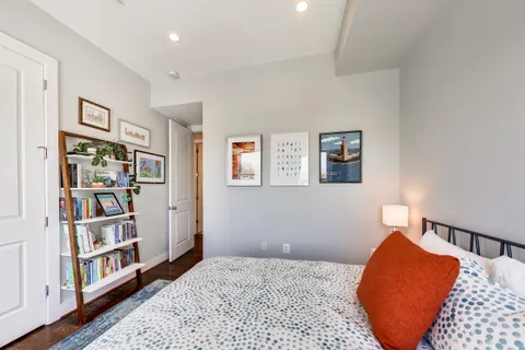 a bedroom with a bed and a book shelf