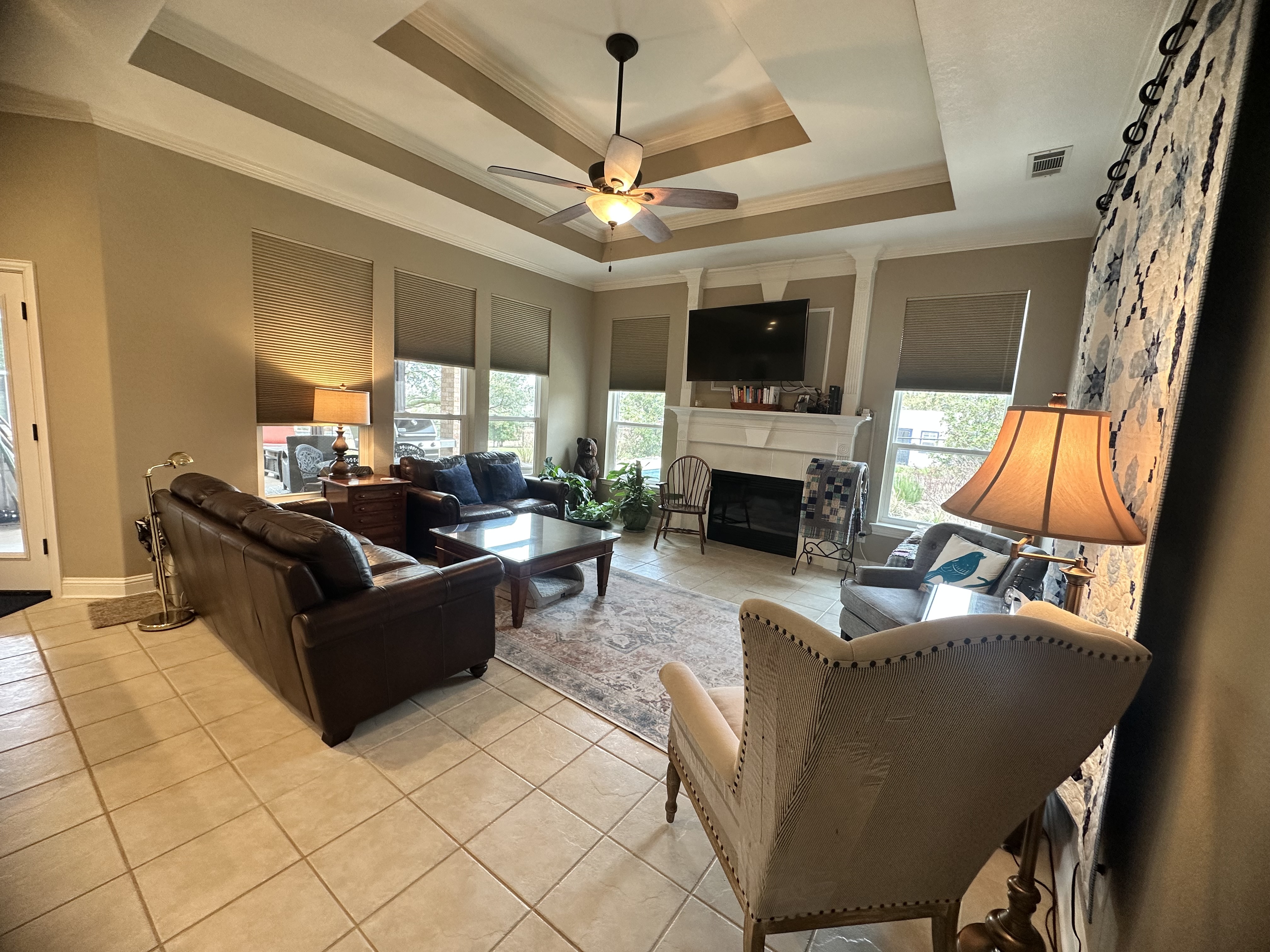 3588 Heritage Trail Celina, TX 75009 - Photo 15 of 19 a living room with furniture a flat screen tv and a fireplace