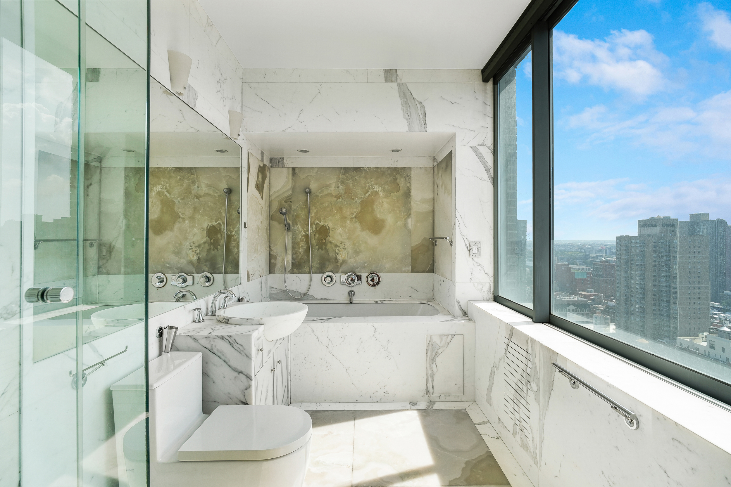 360 East 88th Street, Unit 34A Manhattan, NY 10128 - Photo 13 of 35 a bathroom with a double vanity sink and mirror