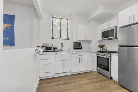 a kitchen with stainless steel appliances granite countertop a stove a sink and a refrigerator