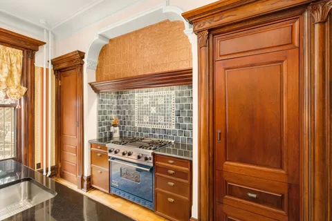 a kitchen with a stove and a cabinet