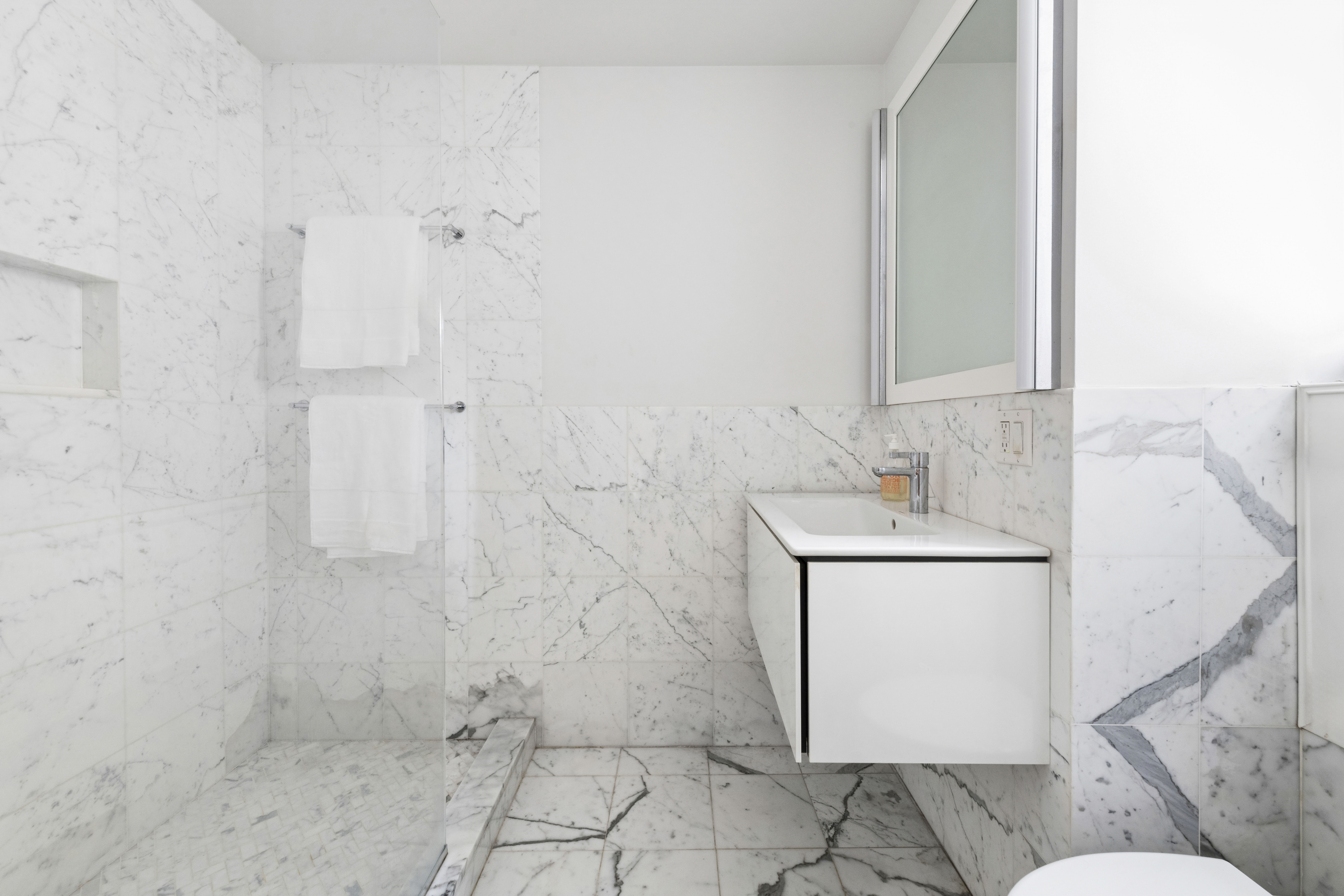 520 East 86th Street, Unit 9B Manhattan, NY 10028 - Photo 10 of 18 a bathroom with a sink toilet and shower