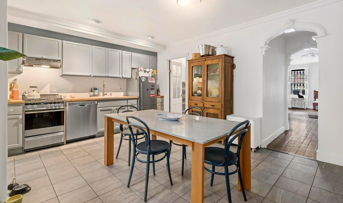 385 Madison Street, Unit 1 Brooklyn, NY 11221 - Photo 16 of 21 a view of a dining room with furniture and a kitchen