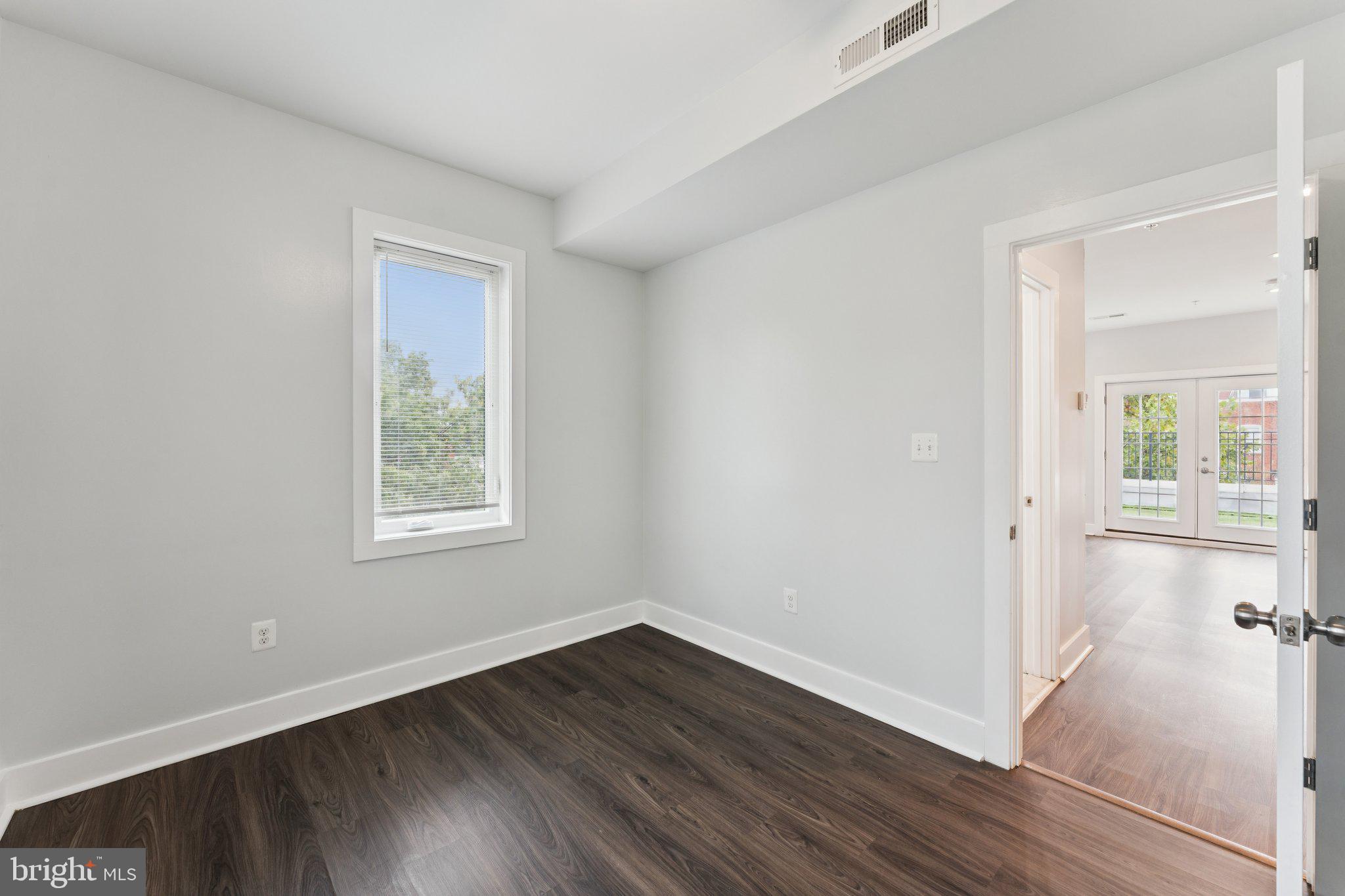 2822 28th Street Southeast Washington, DC 20020 - Photo 40 of 57 an empty room with wooden floor and windows