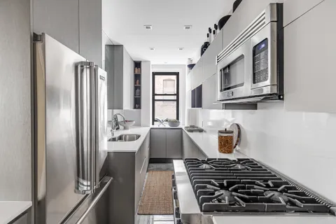 a kitchen with stainless steel appliances granite countertop a stove and a refrigerator