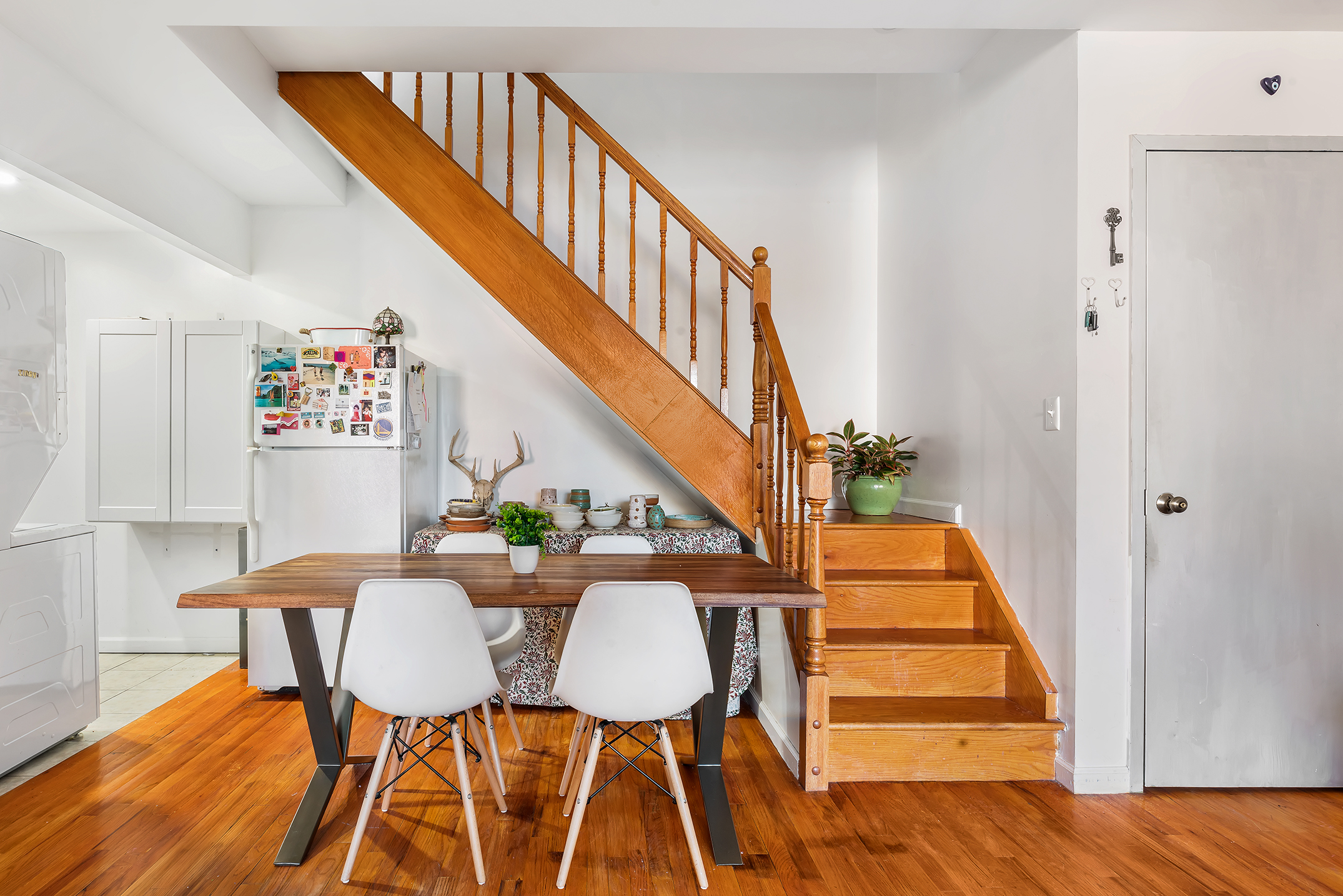 a dining room with furniture and wooden floor