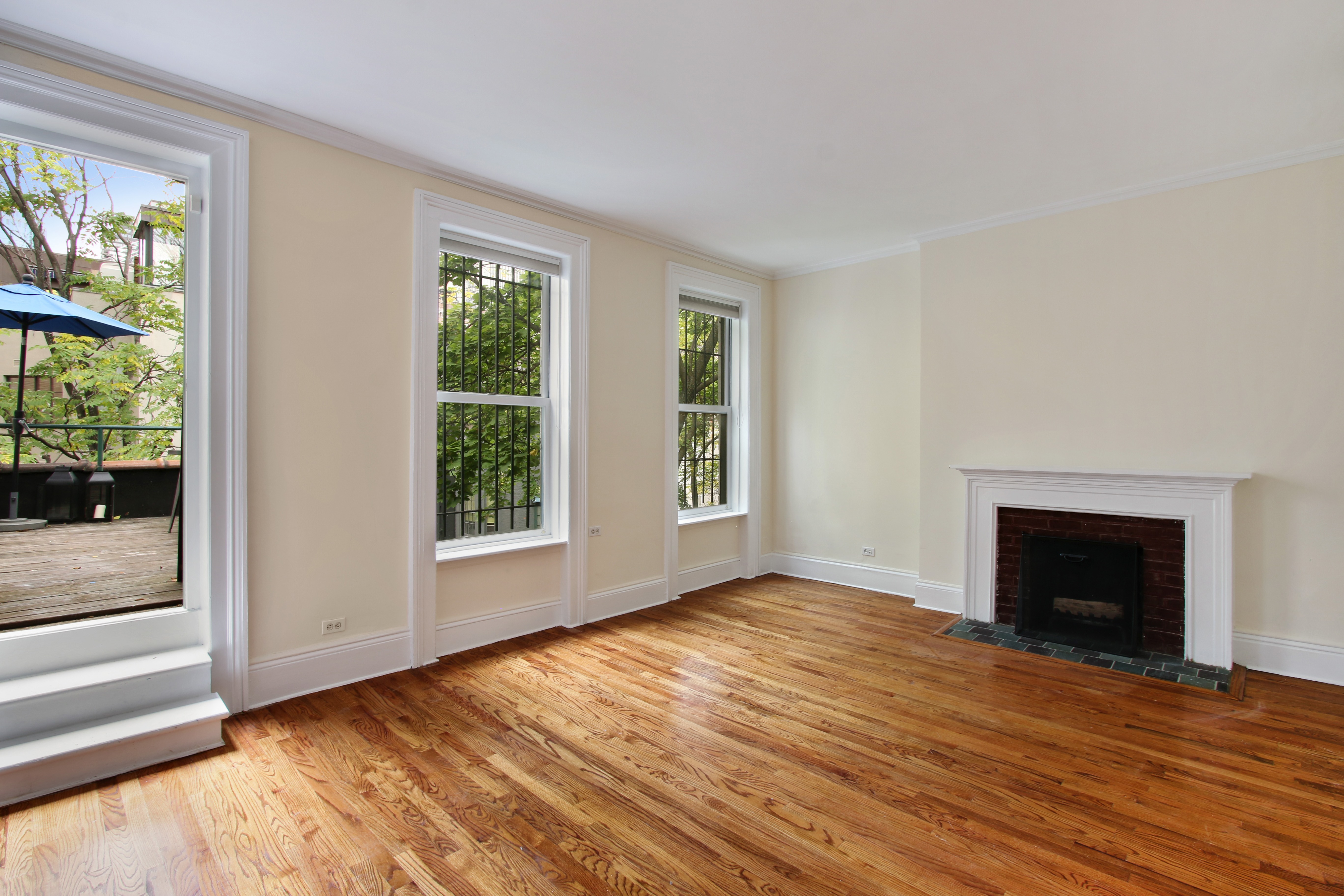 128 East 65th Street Manhattan, NY 10065 - Photo 9 of 10 a view of an empty room with wooden floor and a window
