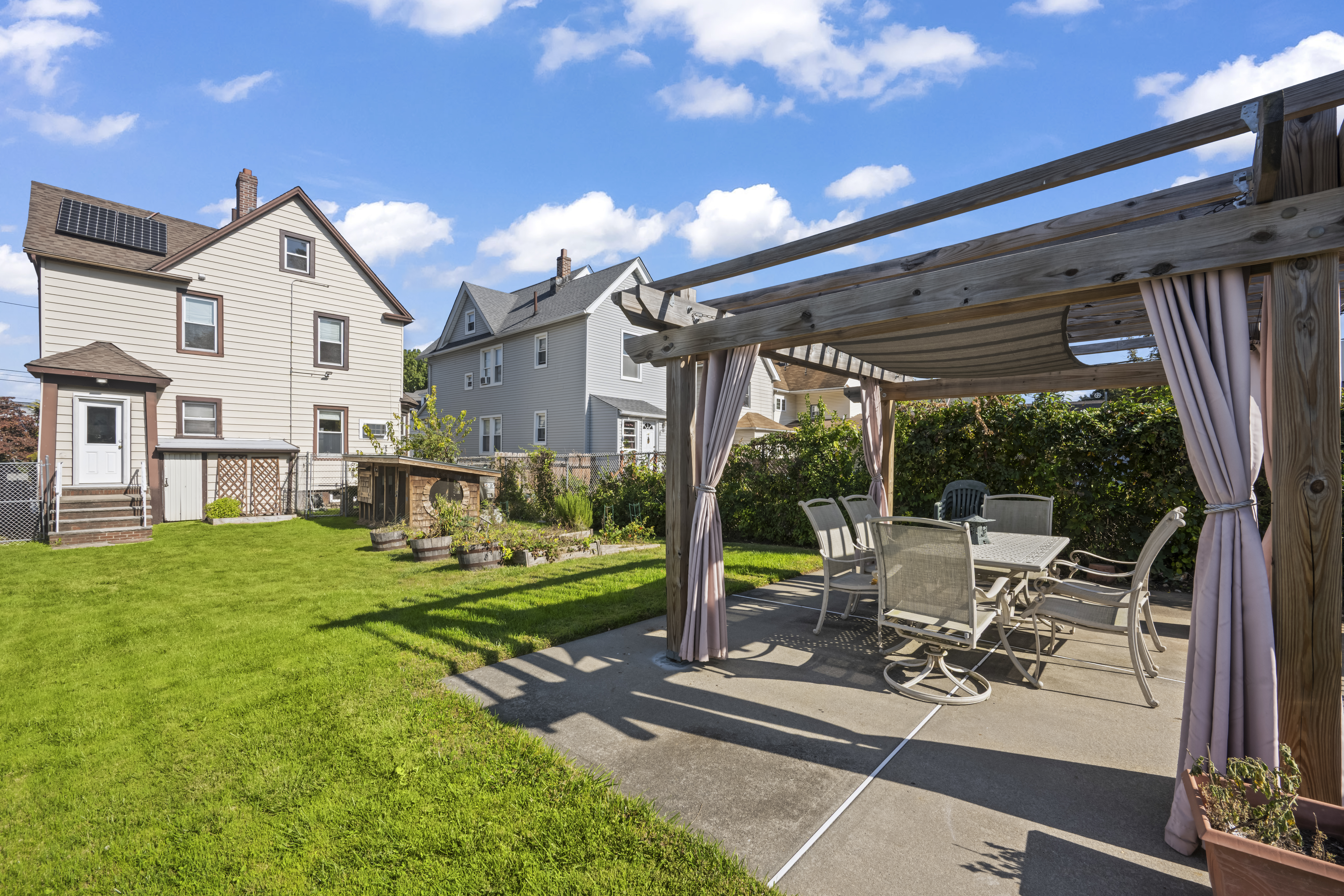 704 Delafield Avenue Staten Island, NY 10310 - Photo 28 of 35 a view of a house with backyard and porch with furniture