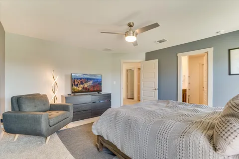 a spacious bedroom with a bed and a couch