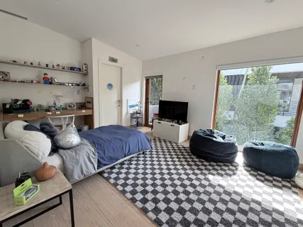 a bedroom with furniture and a flat screen tv