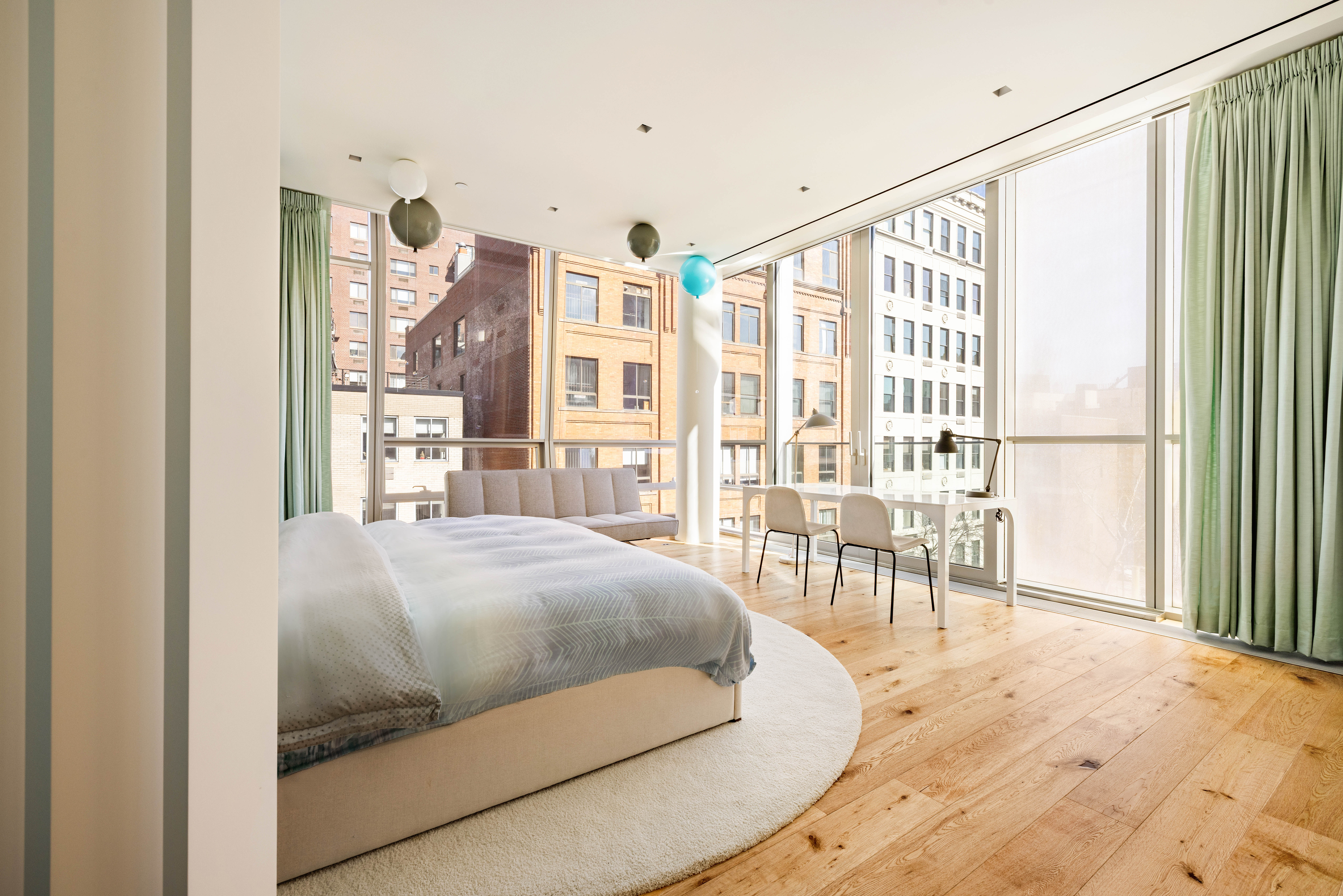 166 Perry Street, Unit 5A Manhattan, NY 10014 - Photo 10 of 25 a living room with a balcony furniture and a floor to ceiling window