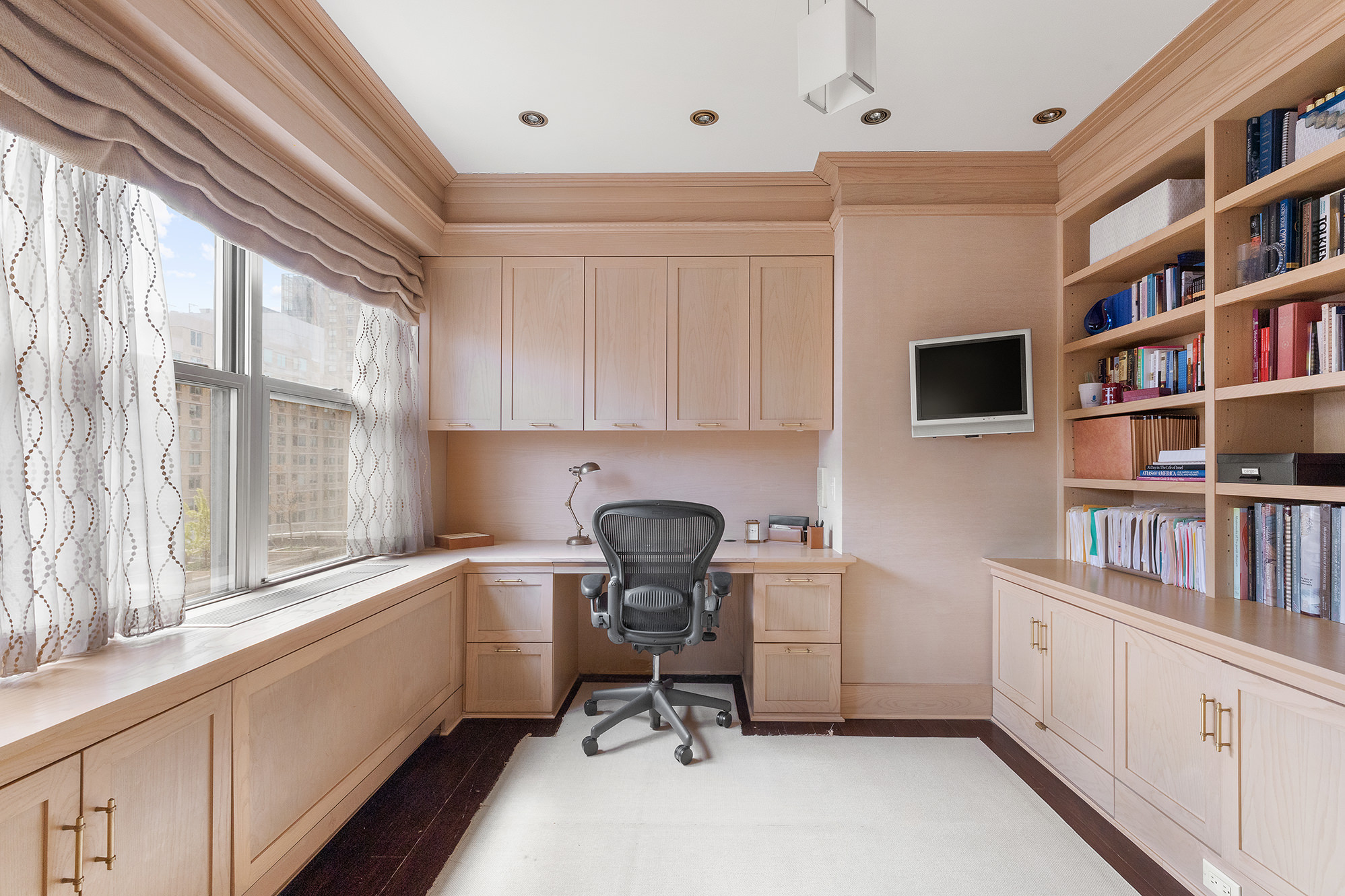 360 East 72nd Street, Unit C1801 Manhattan, NY 10021 - Photo 13 of 20 a view of a workspace with furniture and a window