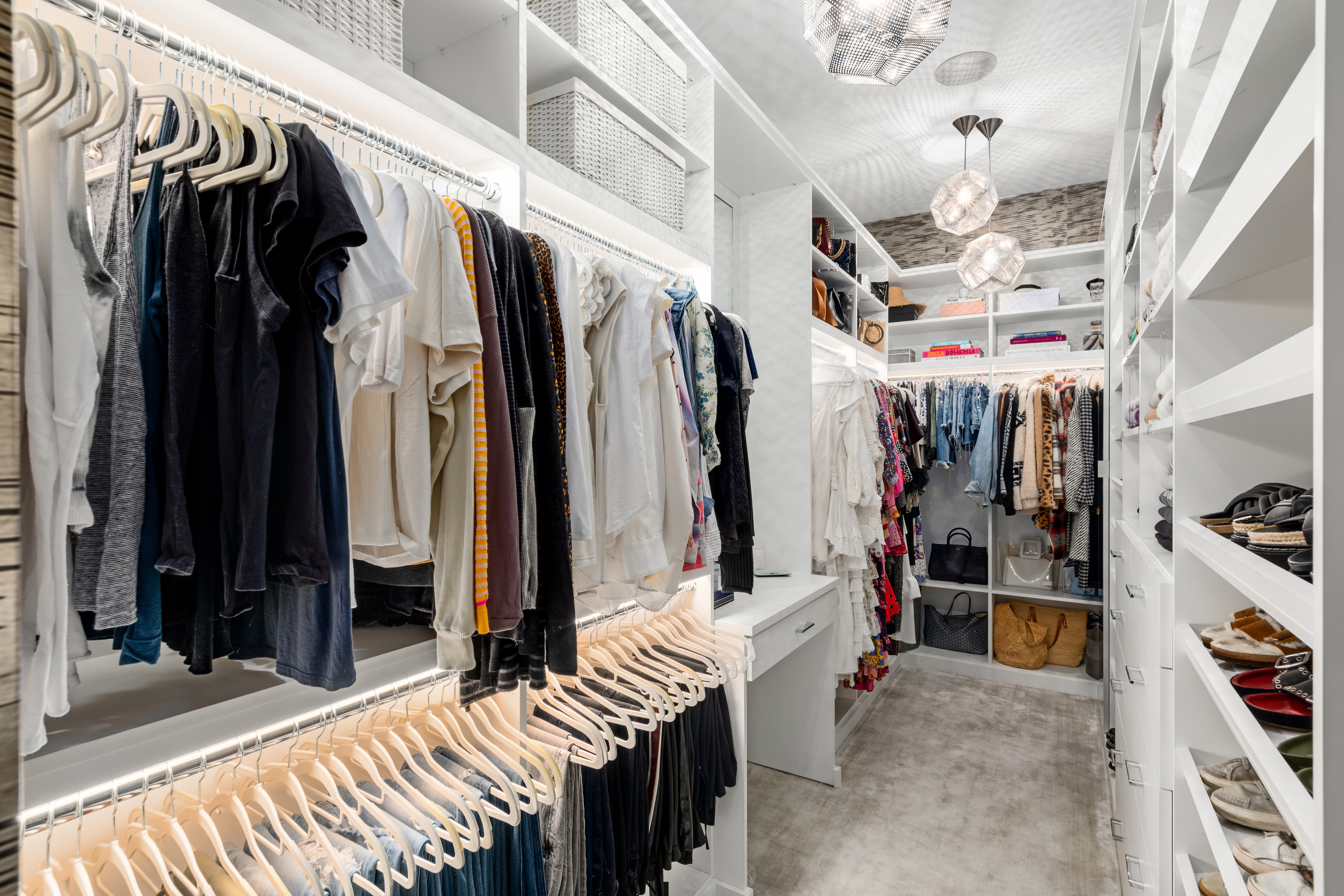 166 Perry Street, Unit 1B Manhattan, NY 10014 - Photo 5 of 17 a view of walk in closet with clothes and shoes