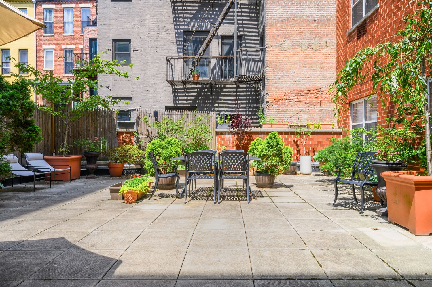 a view of backyard with outdoor seating and plants