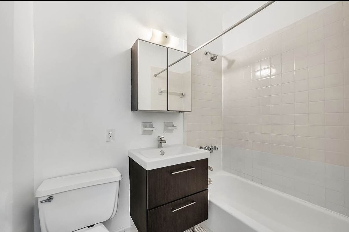 103 West 105th Street, Unit 1B Manhattan, NY 10025 - Photo 6 of 6 a bathroom with a sink a toilet and shower