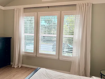 a view of a room with wooden floor and windows