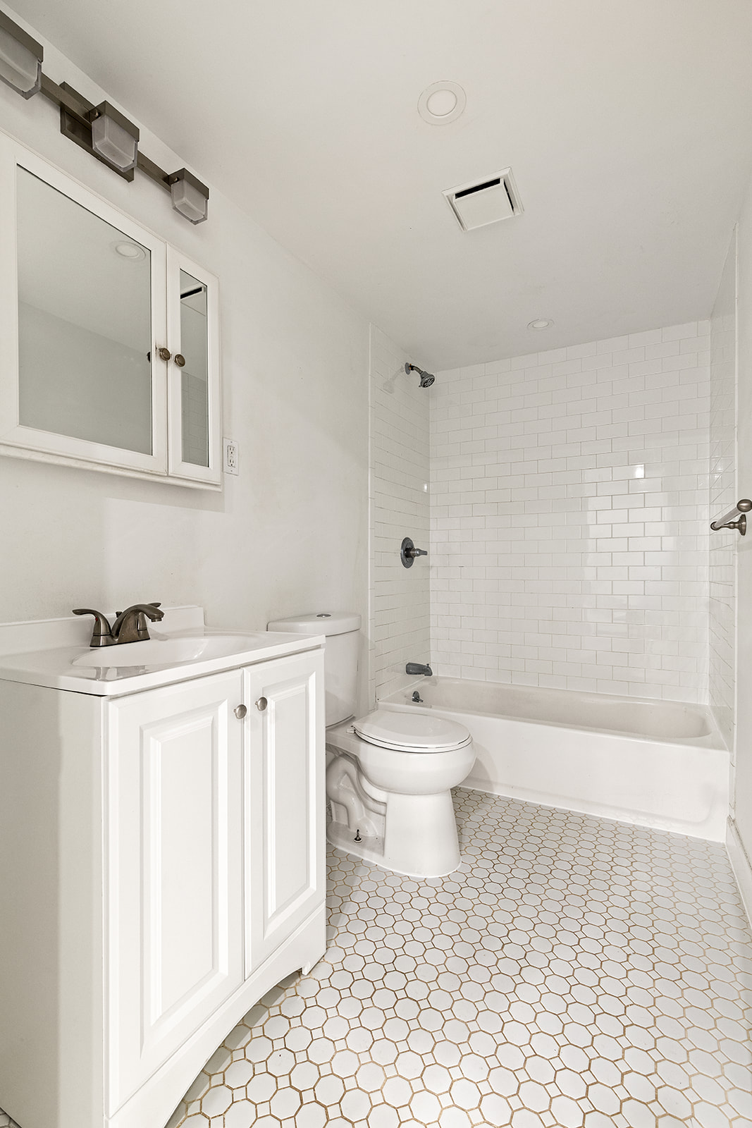 119 Suydam Street Brooklyn, NY 11221 - Photo 13 of 16 a bathroom with a toilet a sink a mirror and shower