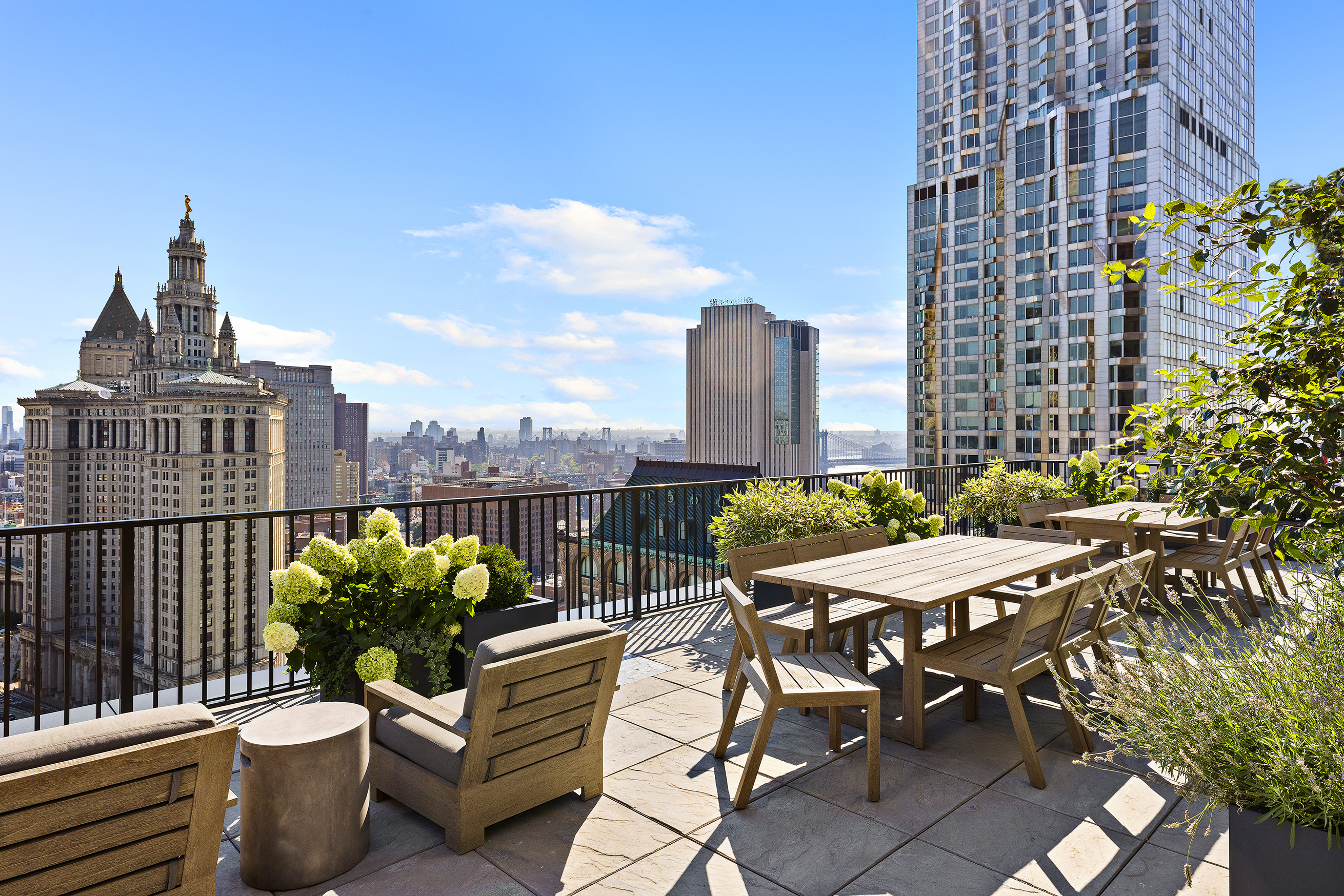 33 Park Row, Unit 10B Manhattan, NY 10038 - Photo 16 of 22 a view of a terrace with chairs and a potted plant