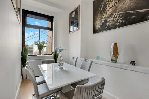 a view of a dining room with furniture and window