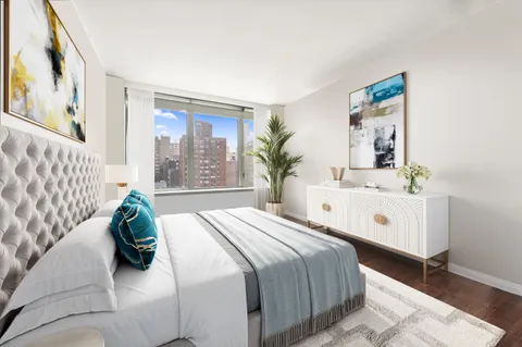 a bedroom with a large bed and a large window