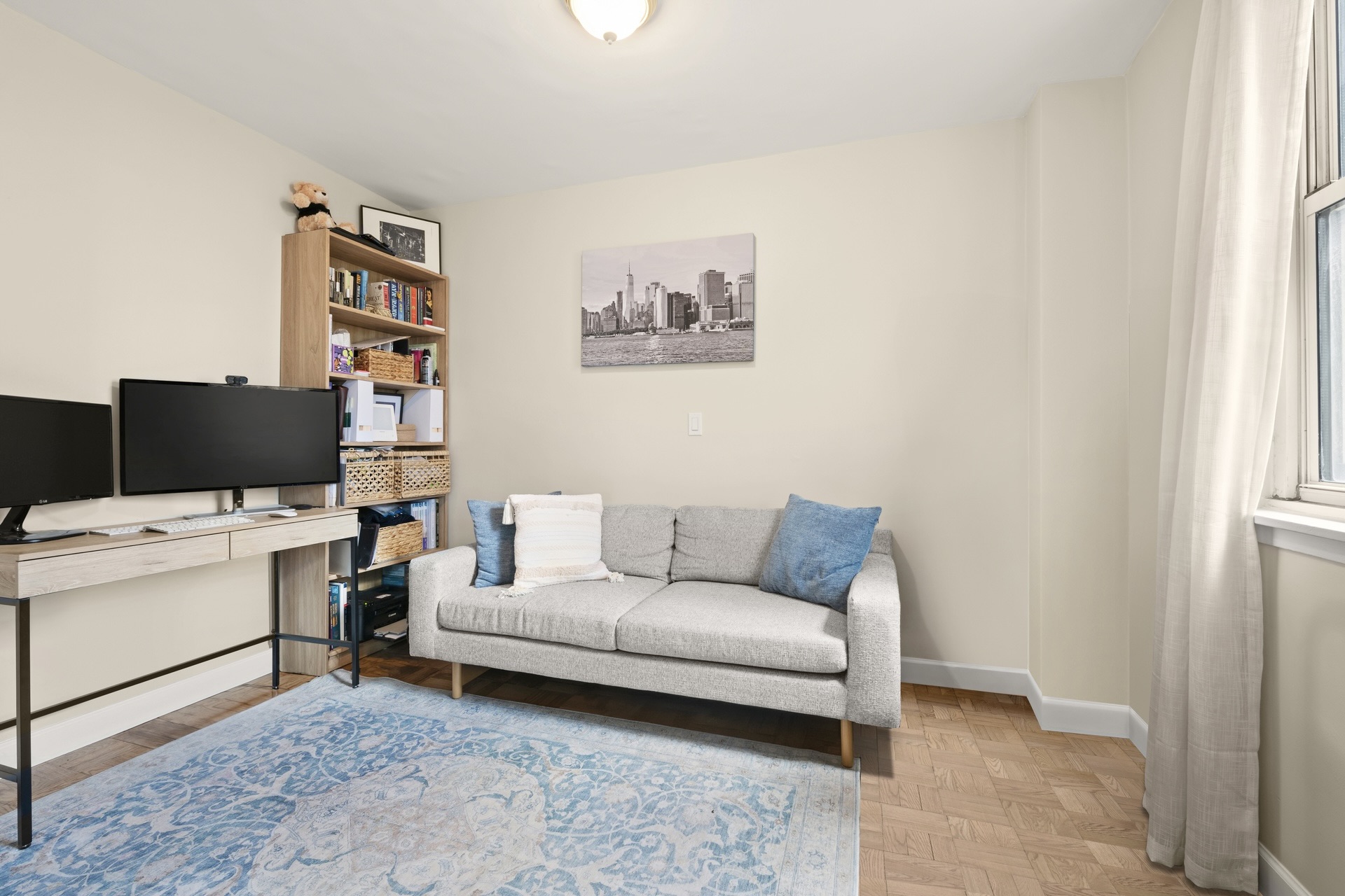200 East 58th Street, Unit 10J Manhattan, NY 10022 - Photo 4 of 8 a living room with furniture and a couch
