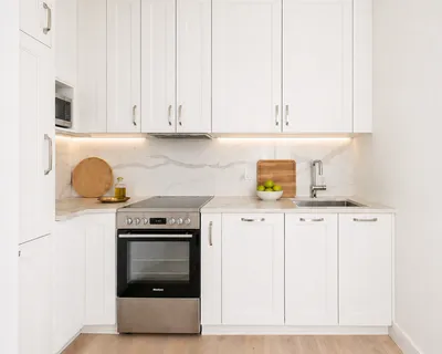 a kitchen with granite countertop a stove sink and cabinets