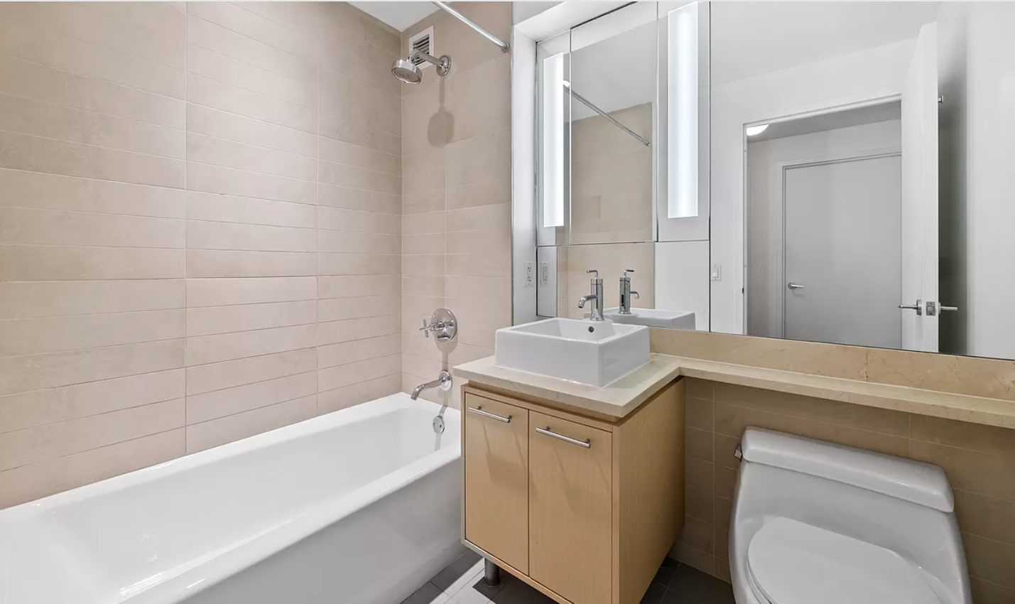 306 Gold Street, Unit 31E Brooklyn, NY 11201 - Photo 6 of 15 a bathroom with a sink toilet vanity and shower