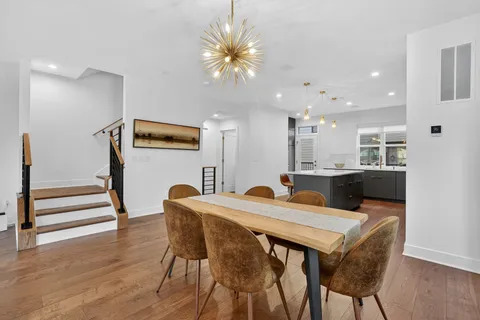 a view of a dining room with furniture and wooden floor