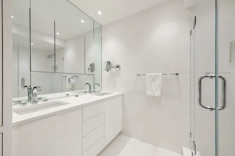 a bathroom with a double vanity sink mirror and double