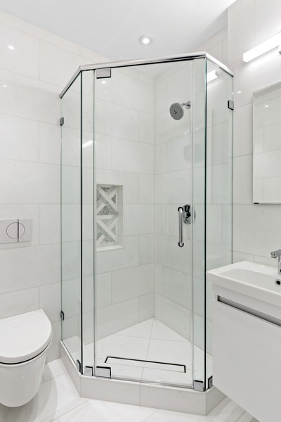 128 West 70th Street, Unit 10 Manhattan, NY 10023 - Photo 10 of 15 a bathroom with a shower a toilet and a sink