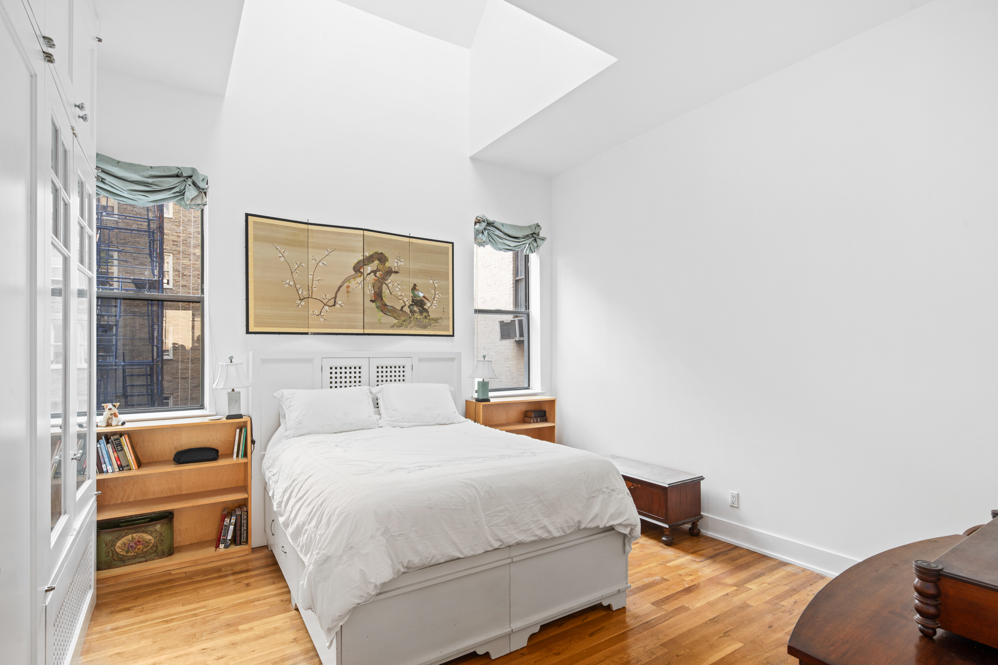 23 East 10th Street, Unit 5A/6A Manhattan, NY 10003 - Photo 5 of 12 a bedroom with a bed and wooden floor