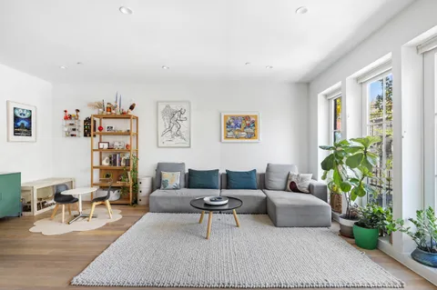 a living room with furniture and flowers