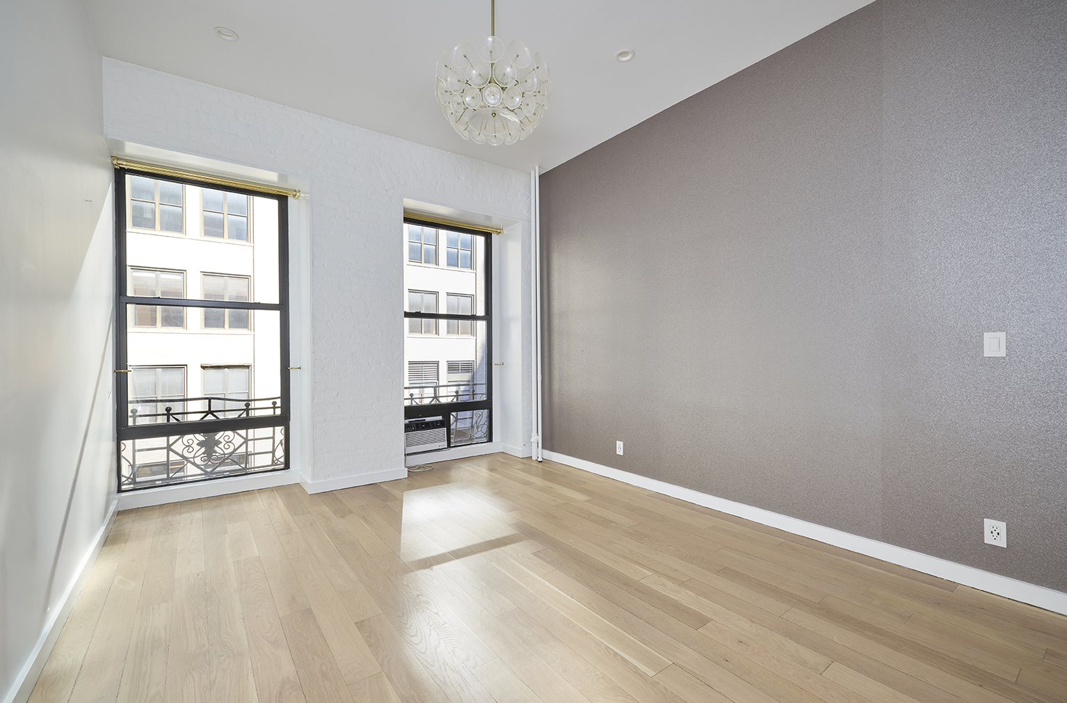 23 East 10th Street, Unit 508 Manhattan, NY 10003 - Photo 14 of 21 wooden floor in an empty room with a window