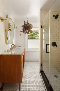 a bathroom with a granite countertop sink a toilet and shower